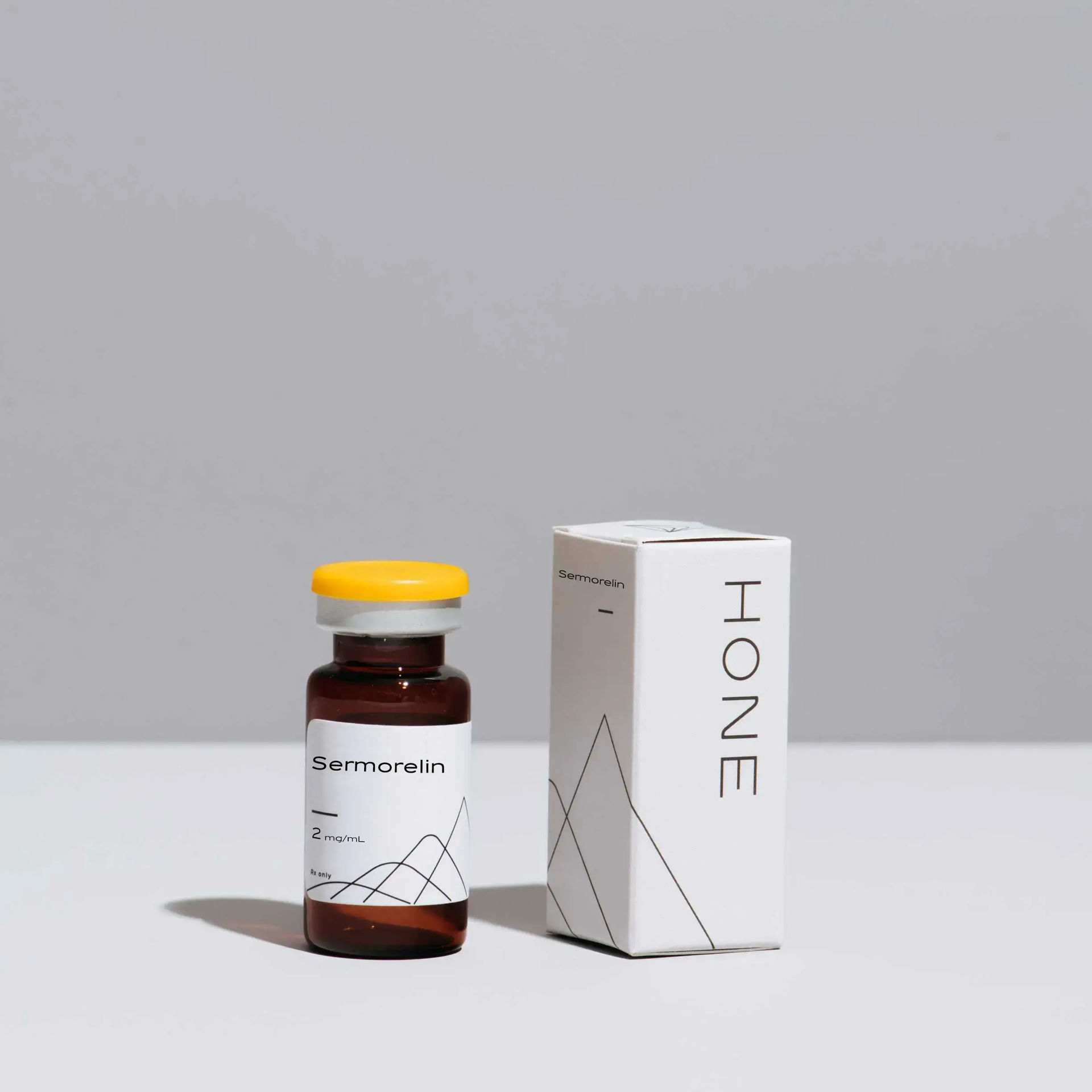 A Hone branded vial of Sermorelin injection with a box sitting next to it